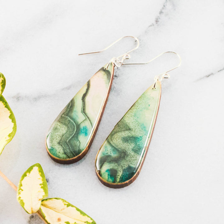 Teardrop green geode inspired wooden earrings with swirling jade turquoise and moss green design