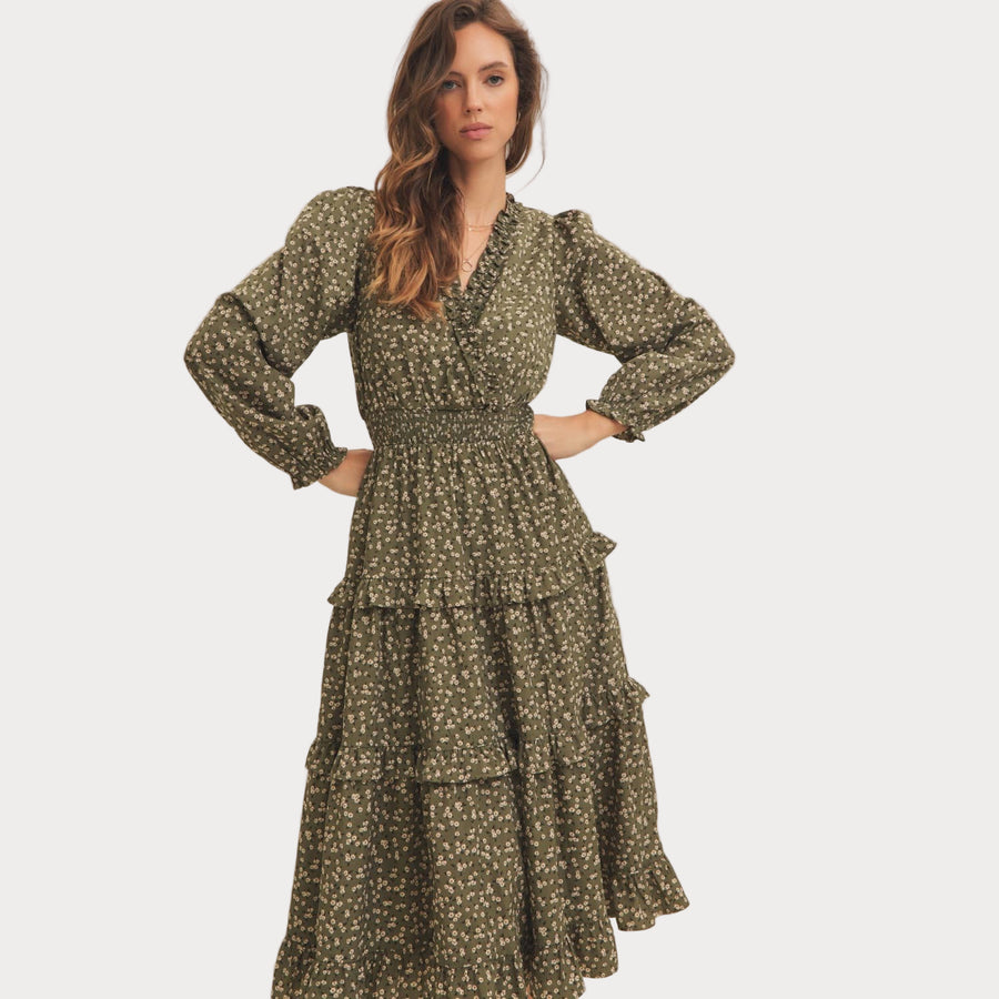 Woman wearing a green floral dress on a white background