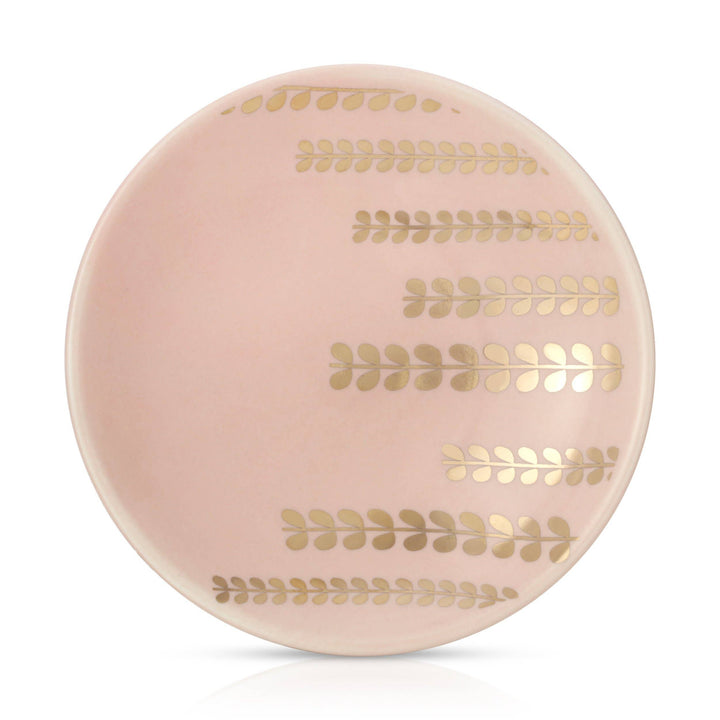 Round trinket dish with gold leaf patterns on a white background
