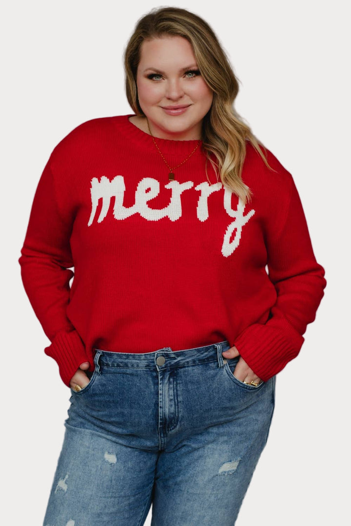 Plus size model wearing a red sweater with 'merry' text against a neutral background