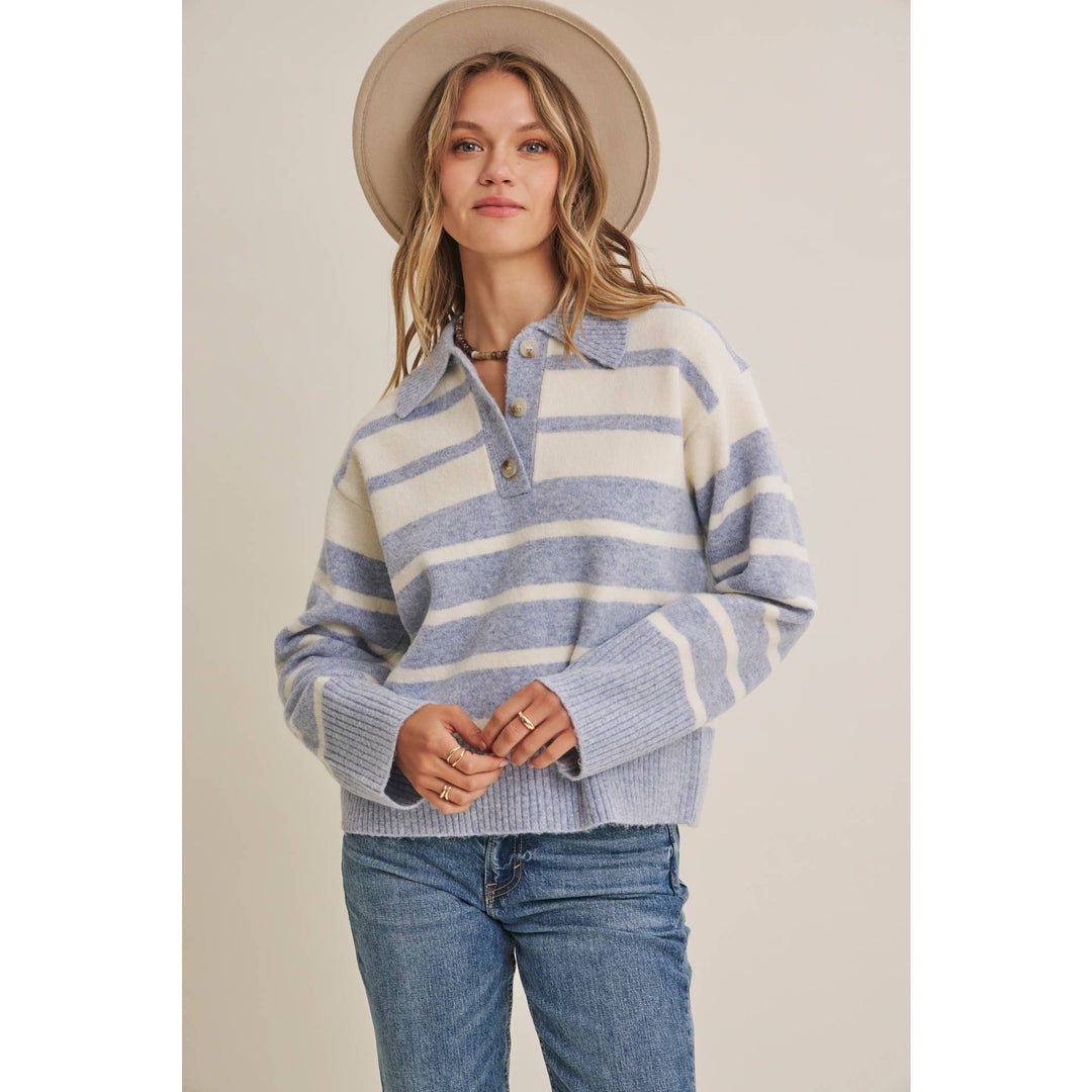 Woman wearing The Marlowe ice blue and ivory striped brushed Henley sweater with blue jeans