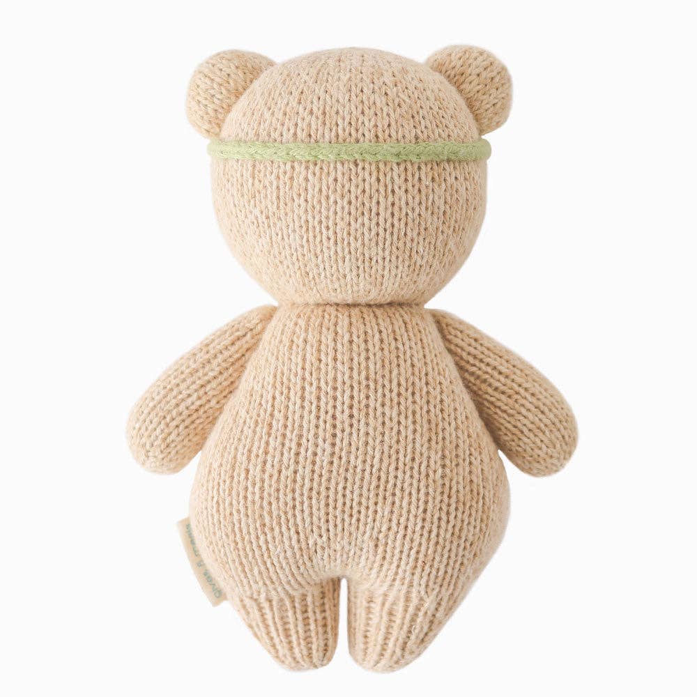 Knitted teddy bear toy on a white background