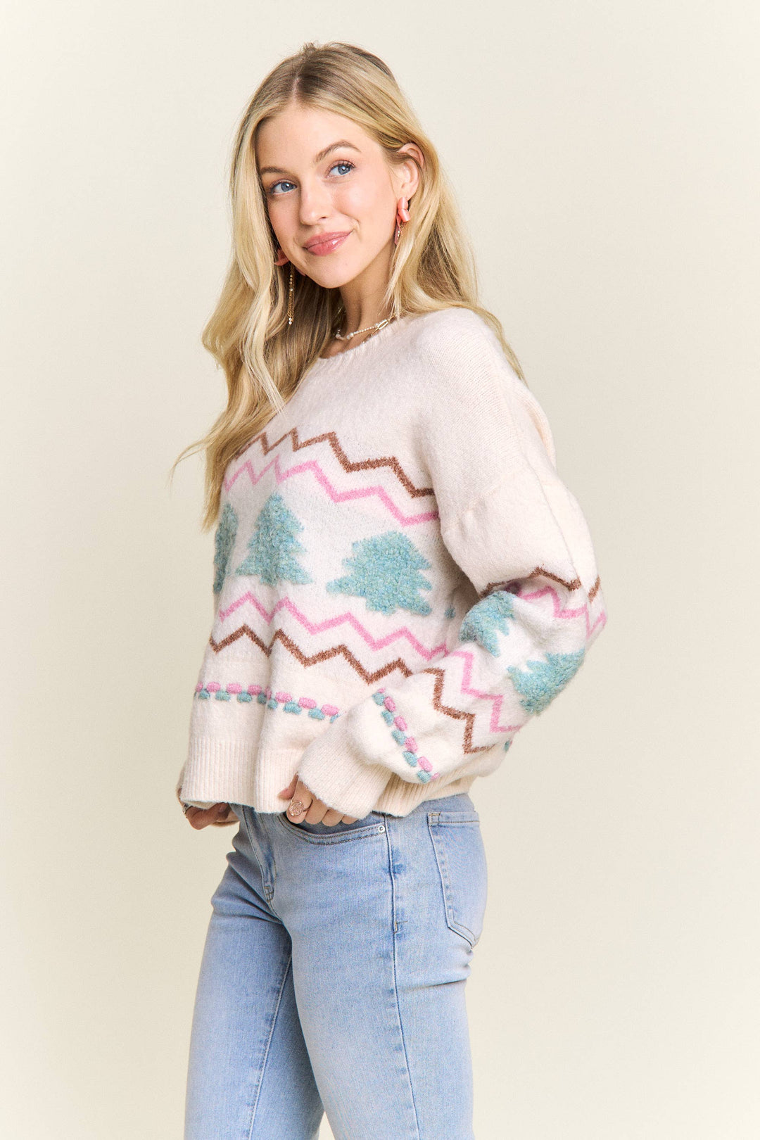 “Cream knit sweater with fluffy textured Christmas trees and pastel chevron stripes”