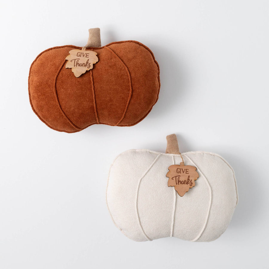 Two fabric pumpkins, one brown and one white, with 'Give Thanks' tags on a light gray background.