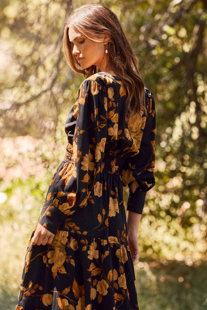 Woman wearing a floral dress in a natural setting