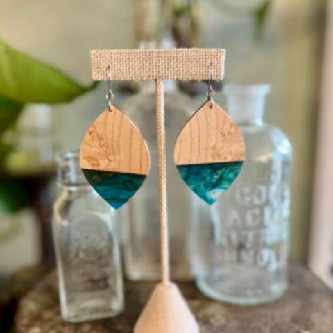 Handcrafted Aquamarine Birdseye Maple Earrings featuring natural maple wood grain, vibrant blue-green resin accents, and hypoallergenic stainless-steel hooks.