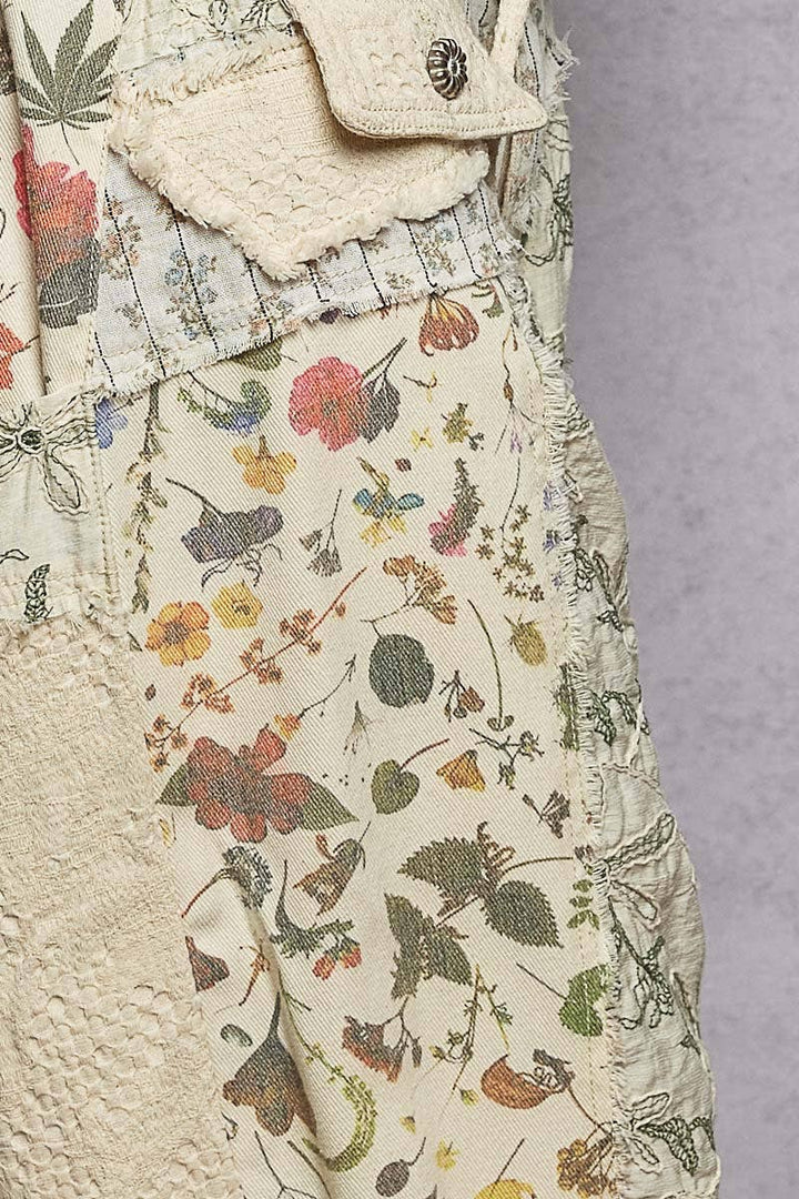 Model wearing The Cottage Bloom Patchwork Joggers by POL featuring vintage-inspired floral patchwork, textured jacquard details, oversized utility pockets, and a relaxed bohemian silhouette.