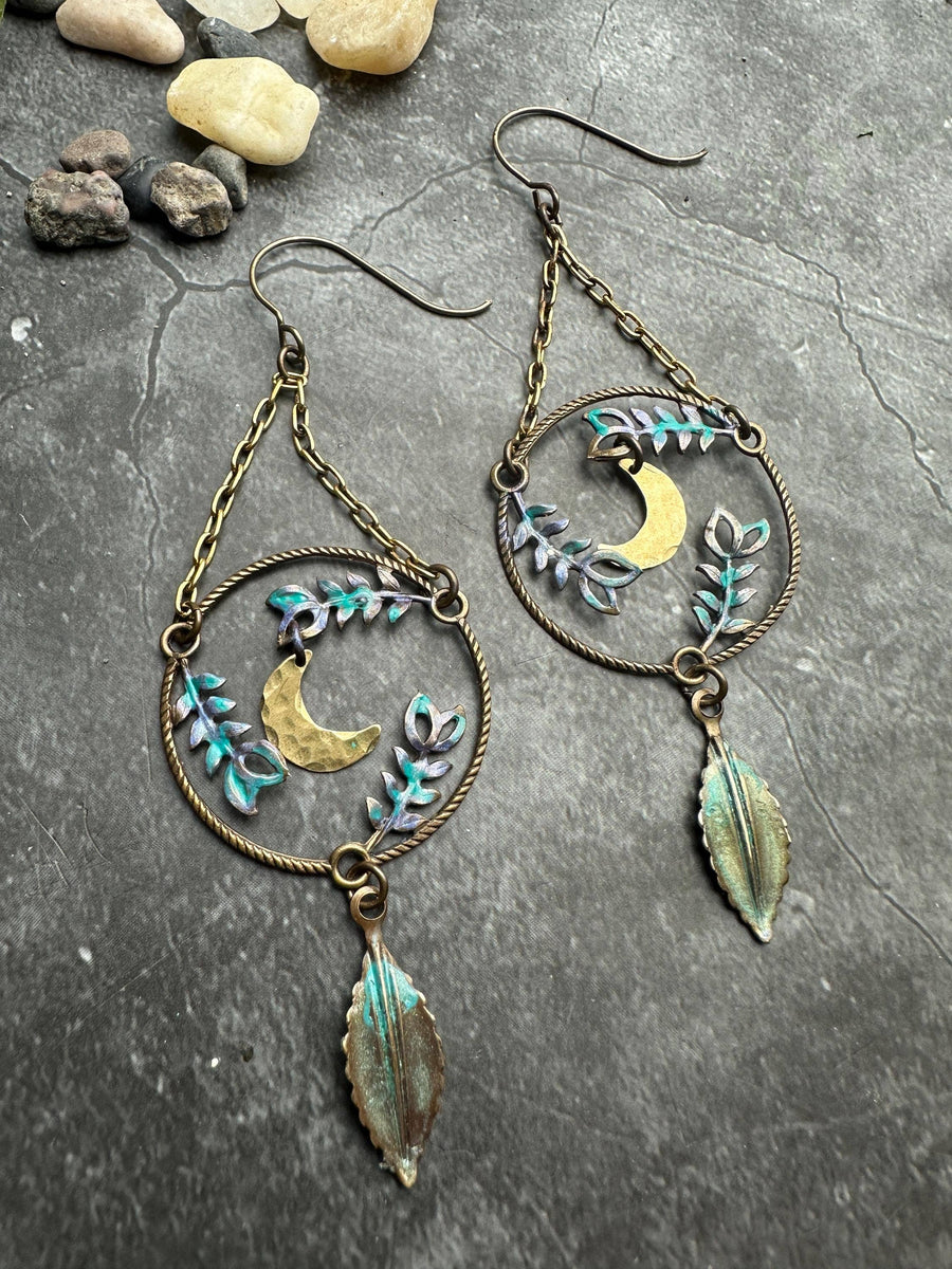 Handcrafted Fern Forest Moon Earrings with hammered brass crescent moons, botanical vines, iridescent patina accents and hanging leaf charms.