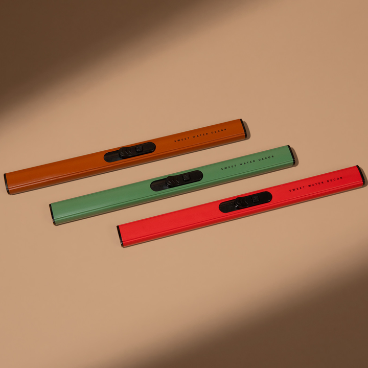 Three rechargable lighters in brown, green, and red on a beige background