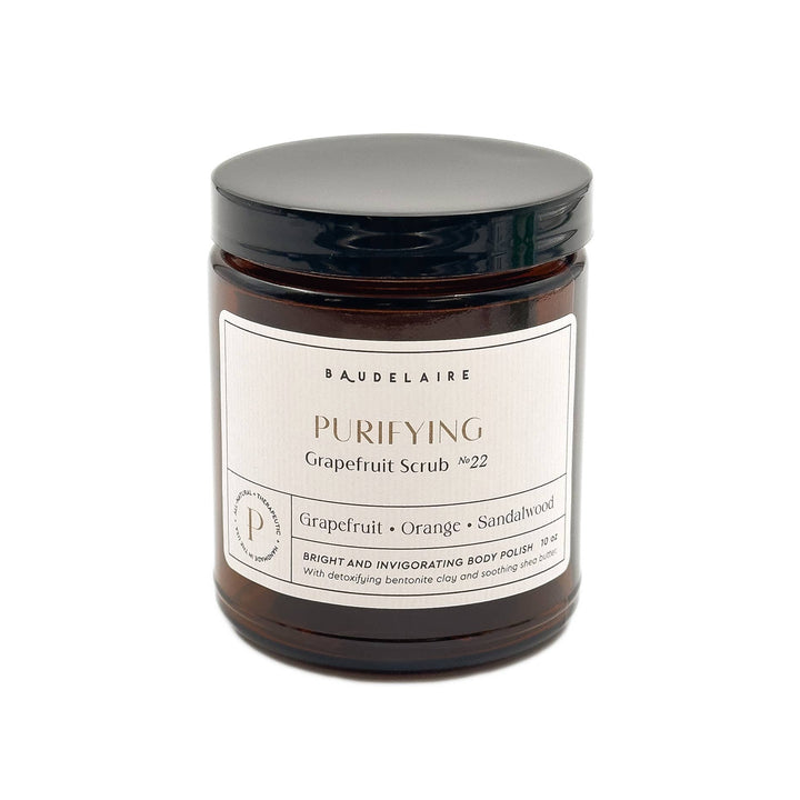 amber jar labeled purifying grapefruit scrub with citrus essential oil blend