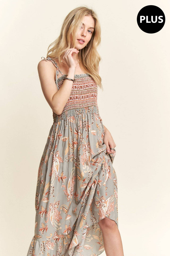 Plus size boho maxi dress with paisley pattern, smocked bodice, and flowy hemline.

