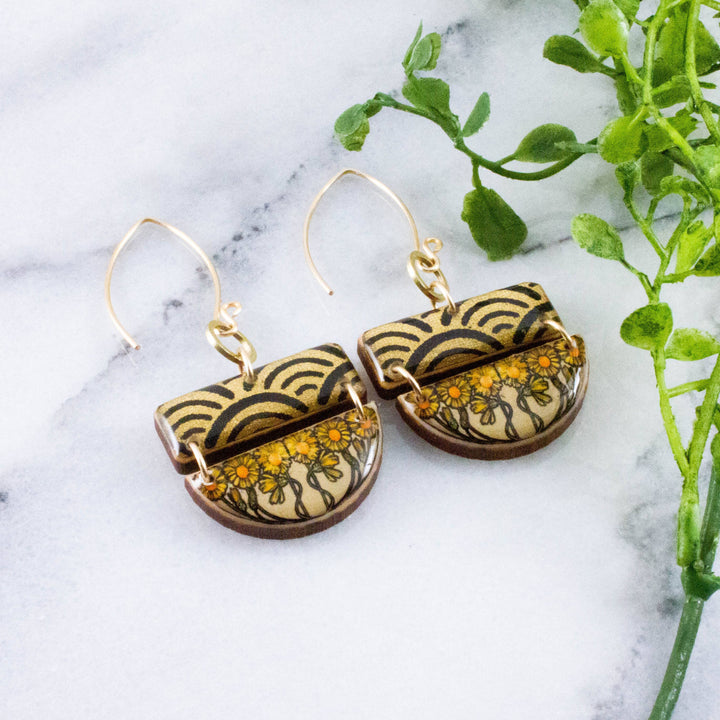 Art Nouveau sunflower stacked half circle wooden earrings with golden floral artwork and black wave pattern