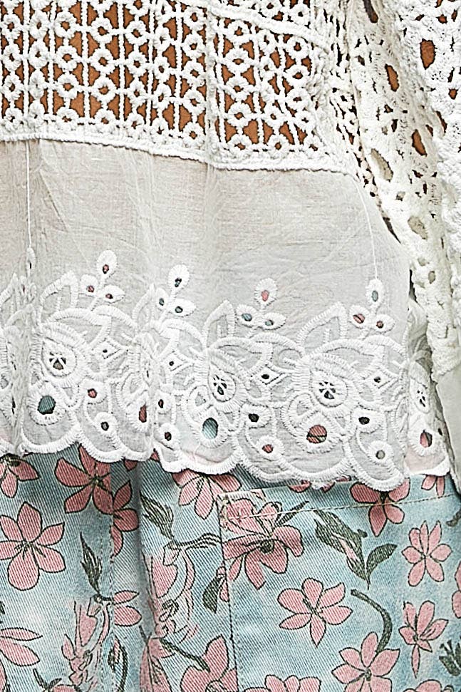 Model wearing The Briar Rose Crochet Blouse featuring intricate open crochet, embroidered eyelet cotton panels, long bell sleeves, and a relaxed bohemian silhouette in ivory.