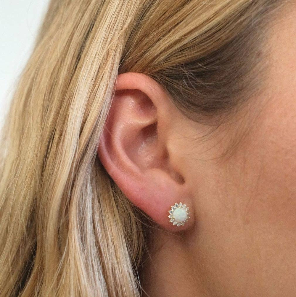 silver opal stud earrings with cubic zirconia halo detail worn by model