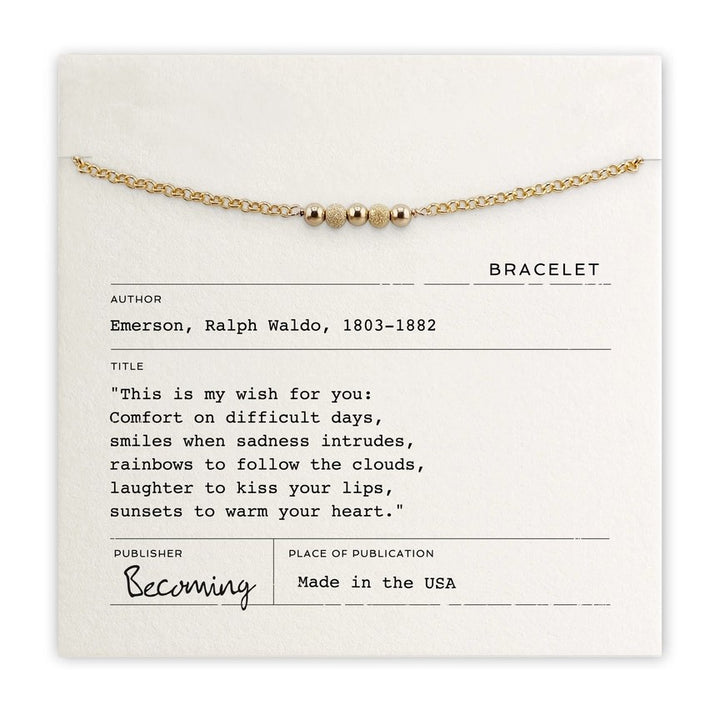 Beaded gold bracelet displayed on quote card reading “This is my wish for you” by Ralph Waldo Emerson, available in gold or silver.