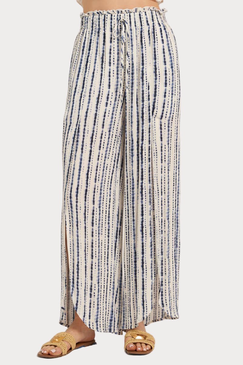 Striped pants worn by a person on a white background