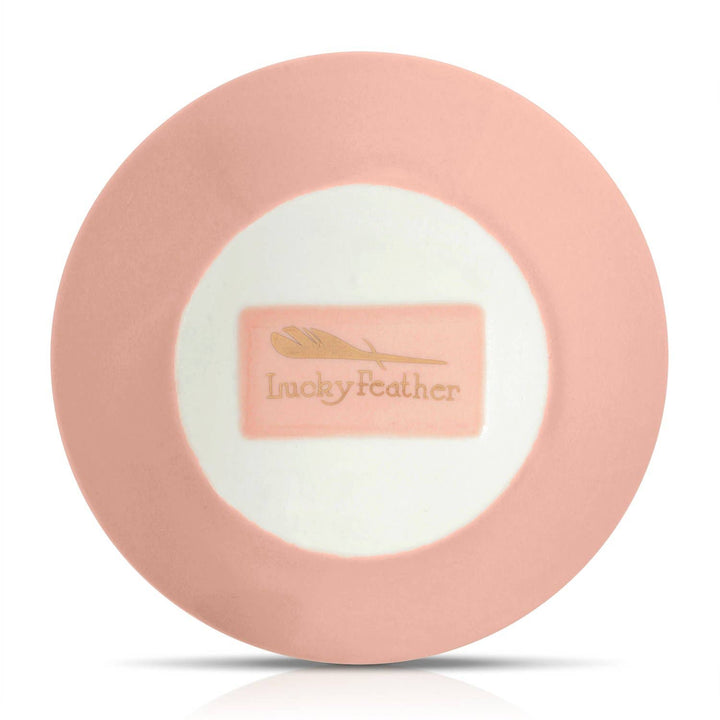 Pink round product with 'Lucky Feather' logo, back of dish, on a white background