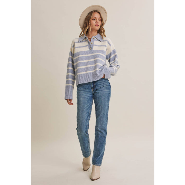 Woman wearing The Marlowe ice blue and ivory striped brushed Henley sweater with blue jeans