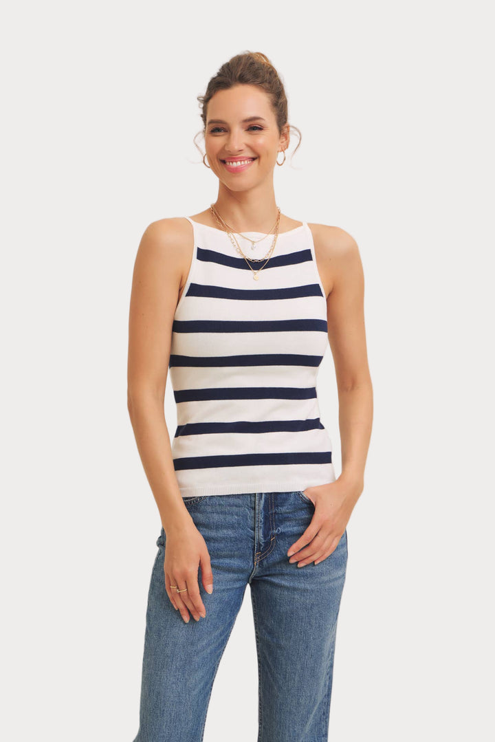 Woman wearing a striped tank top and jeans on a white background