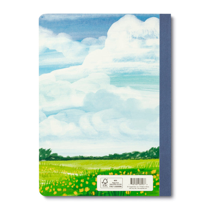 Notebook with a landscape design of clouds and fields on the cover