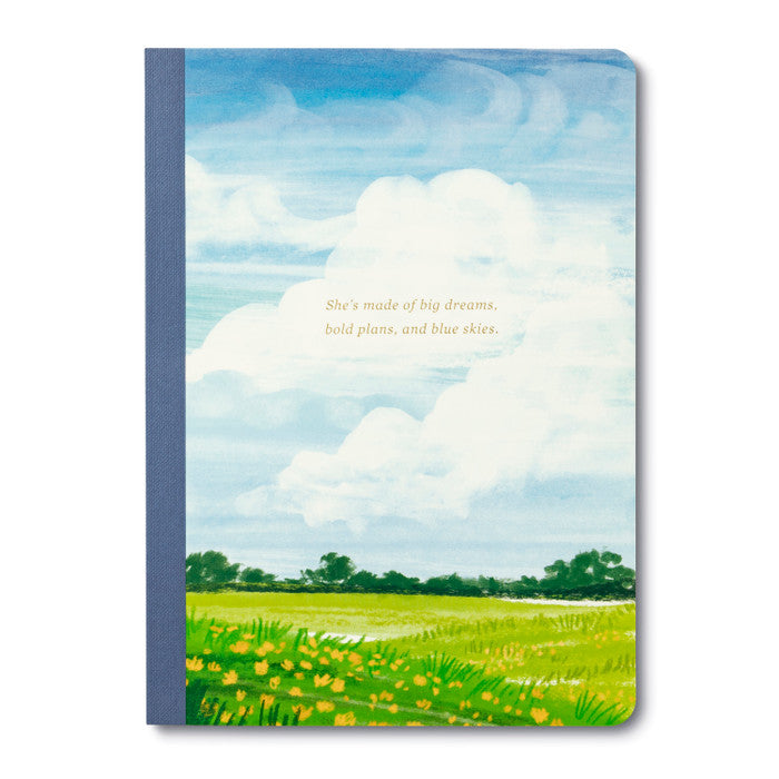 Notebook with a scenic cover of a field and blue sky, featuring text.