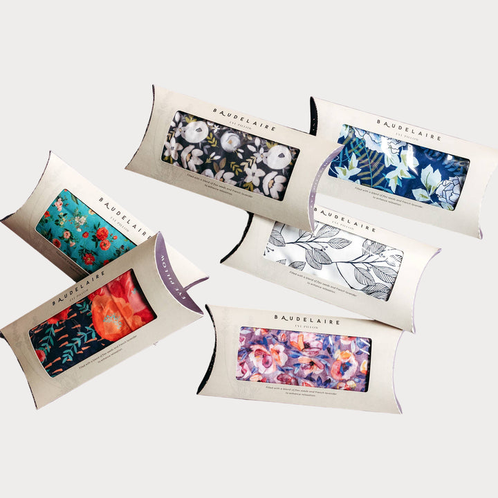 assorted floral lavender eye pillows in boxed packaging with cotton and silk fabrics