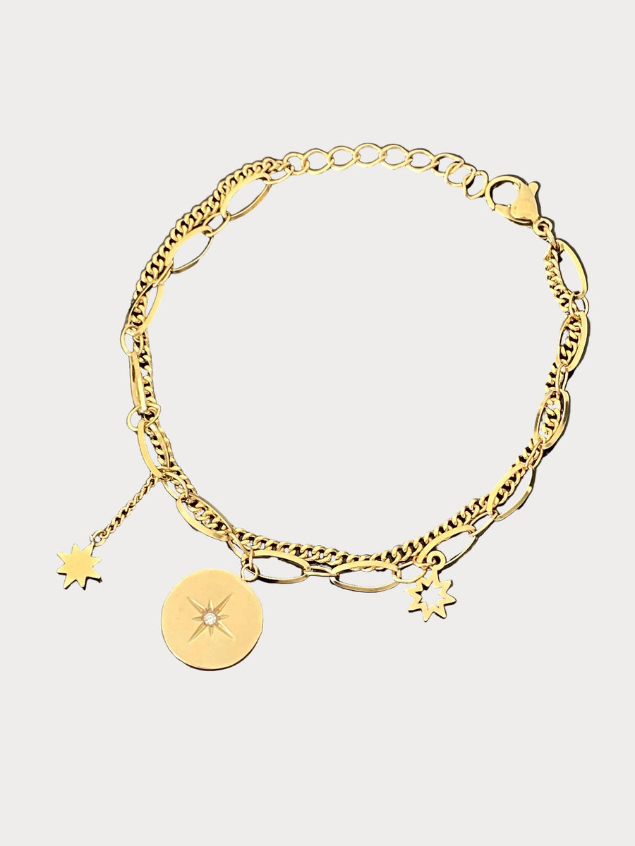Gold layered bracelet with starburst, sun, and star charms