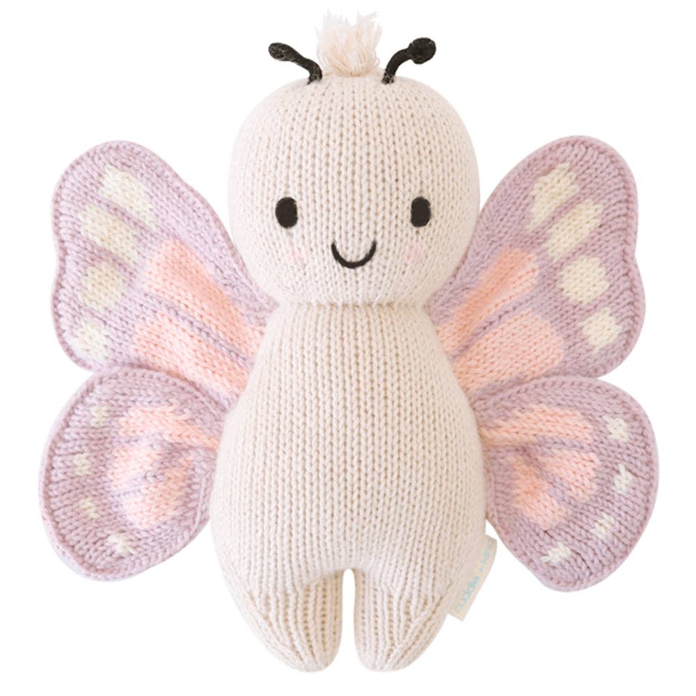 Knitted butterfly toy with pink and purple wings on a white background