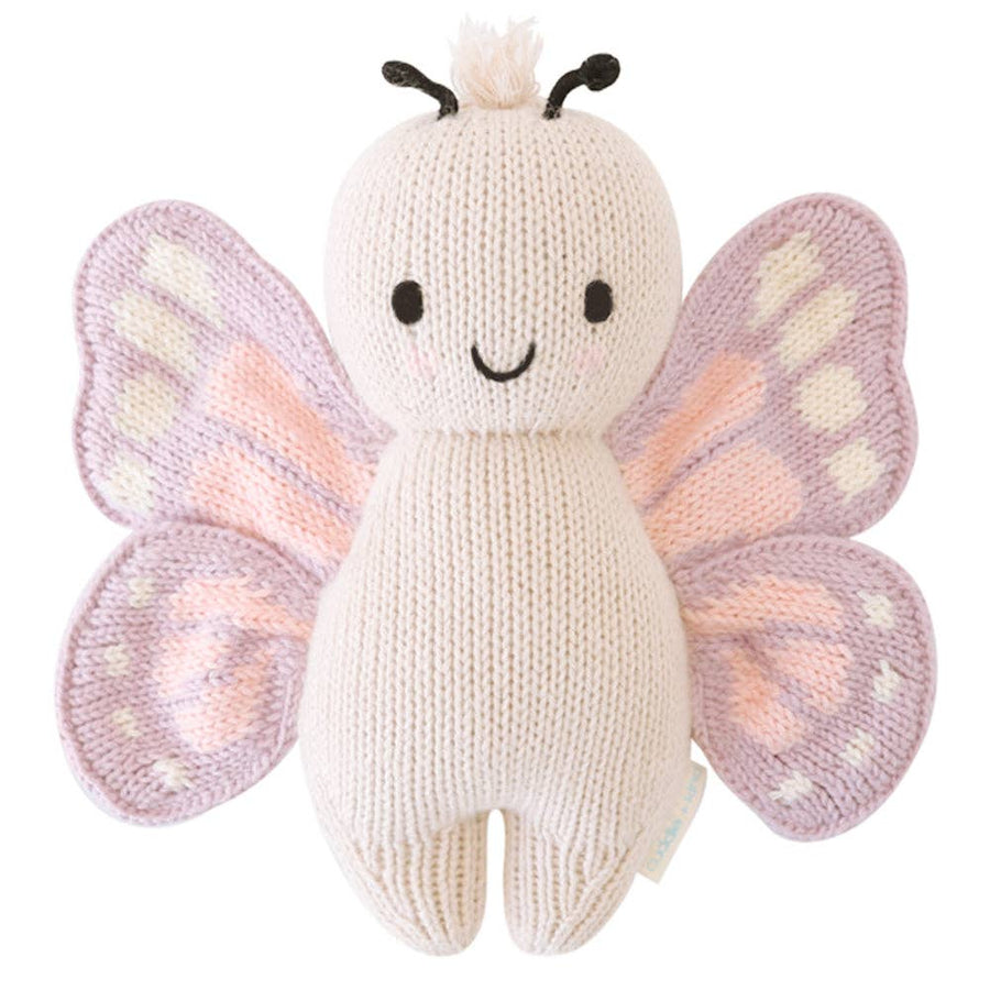 Knitted butterfly toy with pink and purple wings on a white background