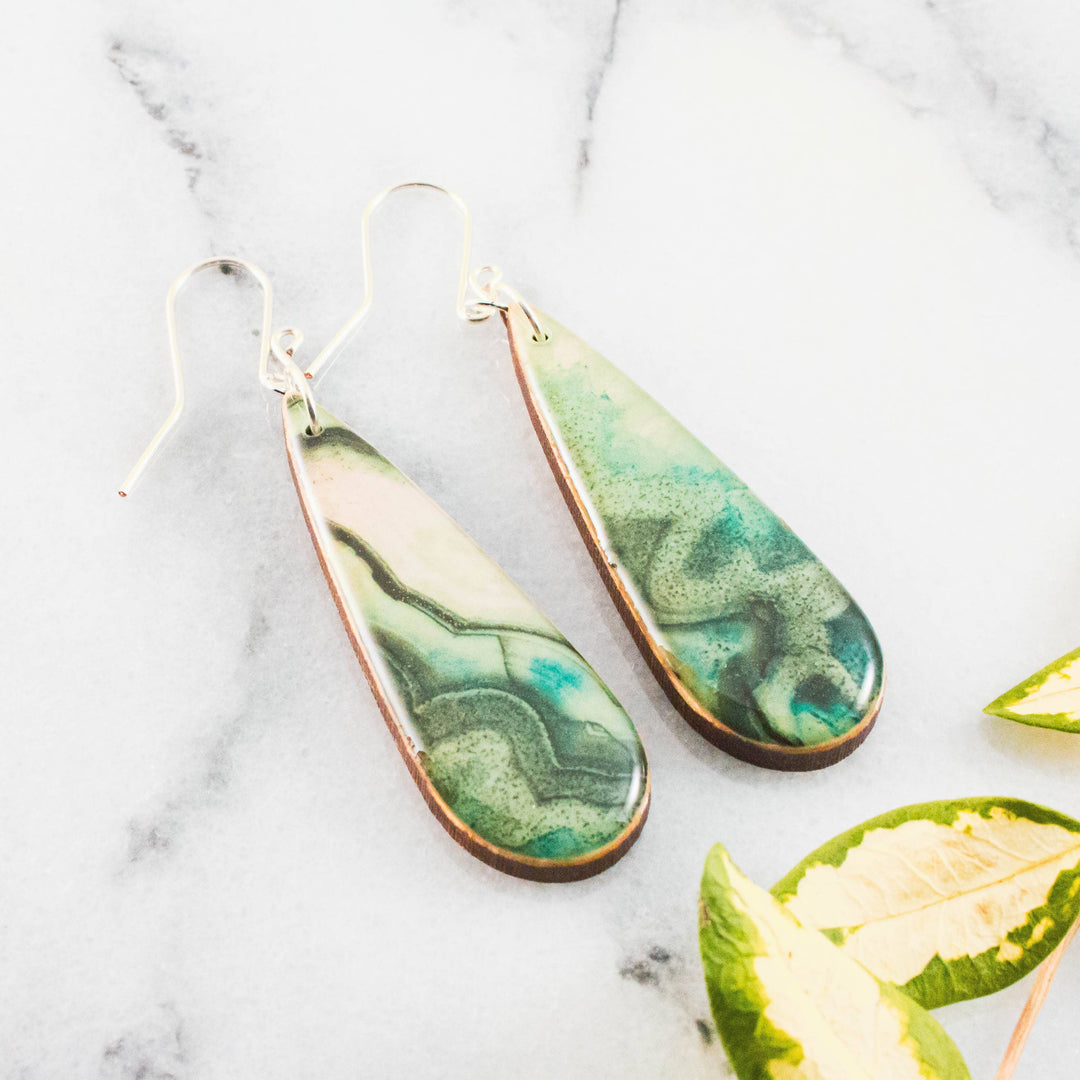 Teardrop green geode inspired wooden earrings with swirling jade turquoise and moss green design