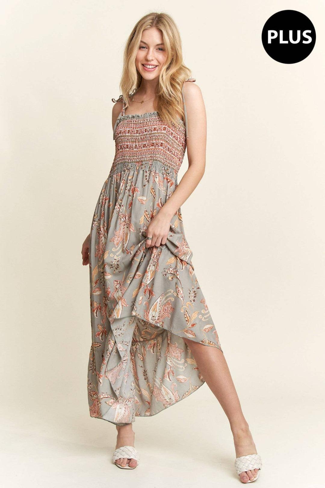 Plus size boho maxi dress with paisley pattern, smocked bodice, and flowy hemline.

