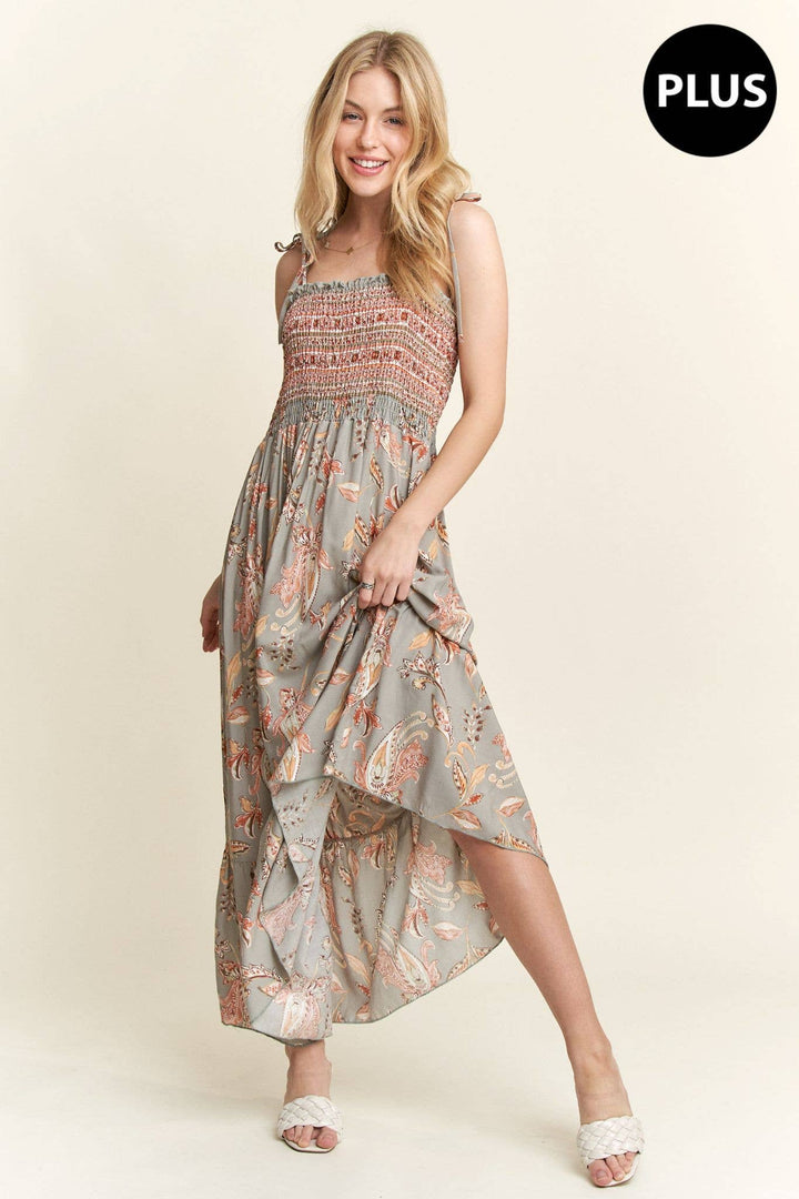 Plus size boho maxi dress with paisley pattern, smocked bodice, and flowy hemline.


