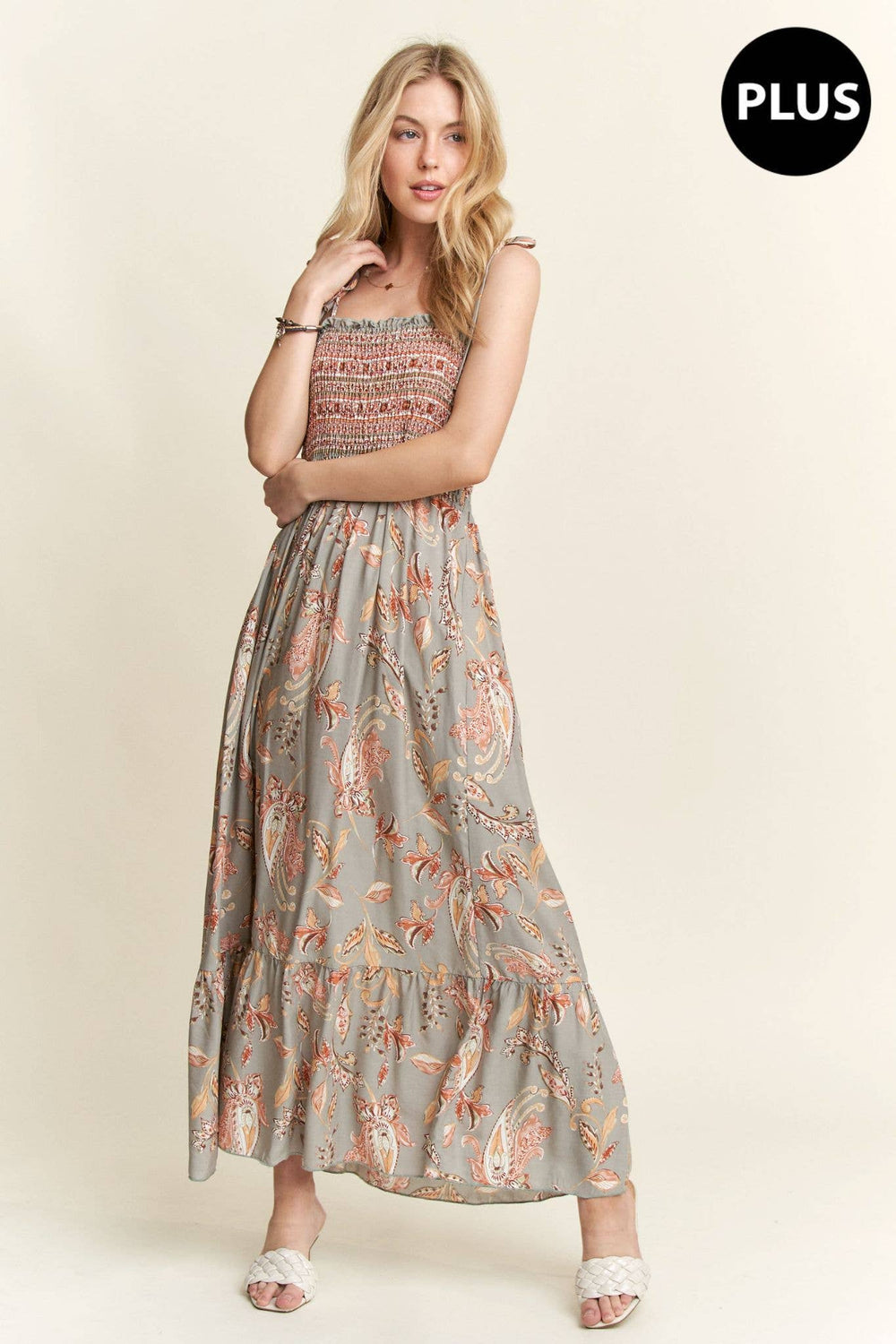 Plus size boho maxi dress with paisley pattern, smocked bodice, and flowy hemline.
