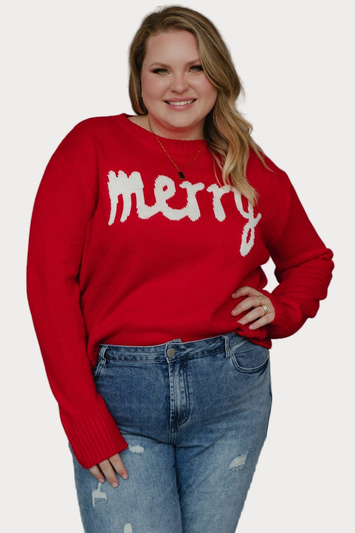 Plus size model wearing a red sweater with 'merry' text against a neutral background