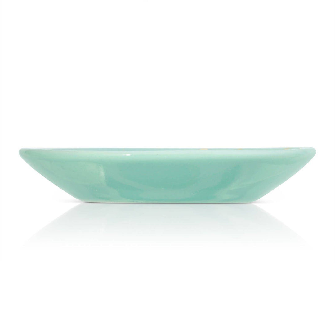 Mint green trinket ceramic dish on a white background