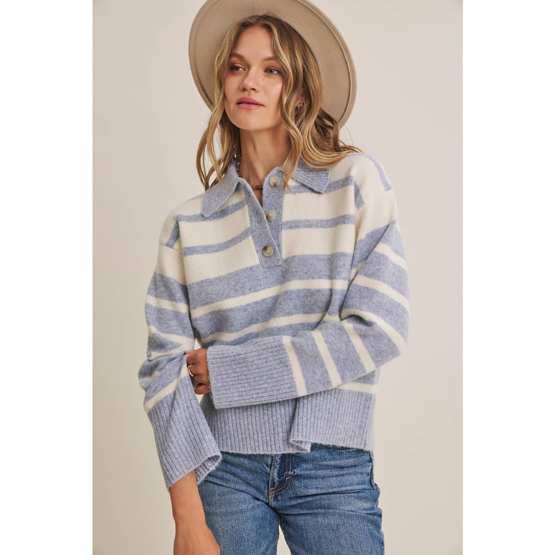 Woman wearing The Marlowe ice blue and ivory striped brushed Henley sweater with blue jeans