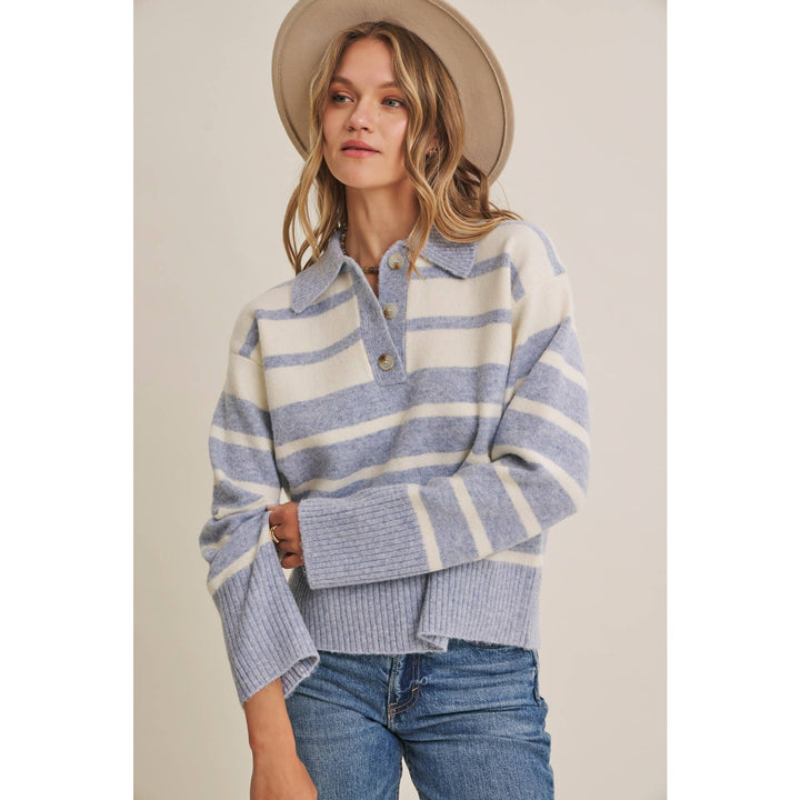 Woman wearing The Marlowe ice blue and ivory striped brushed Henley sweater with blue jeans