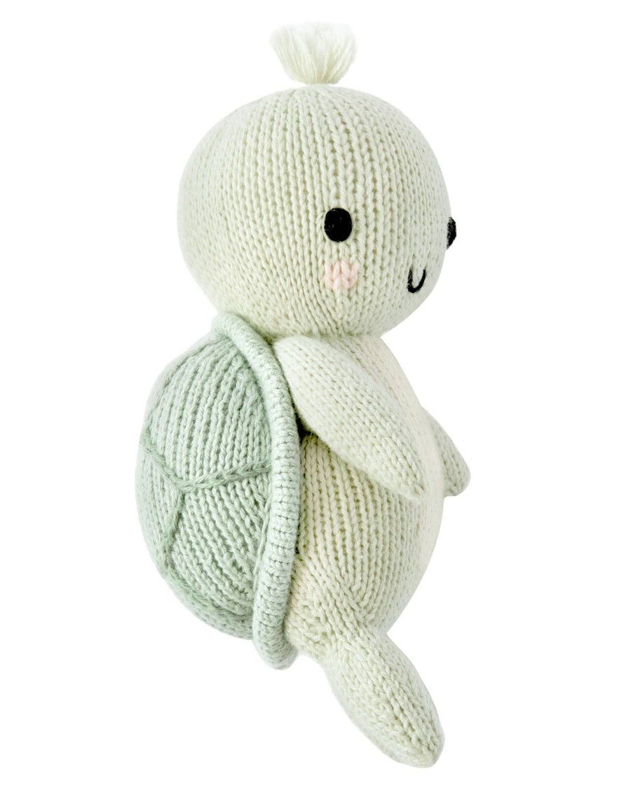 Knitted turtle toy with a white background