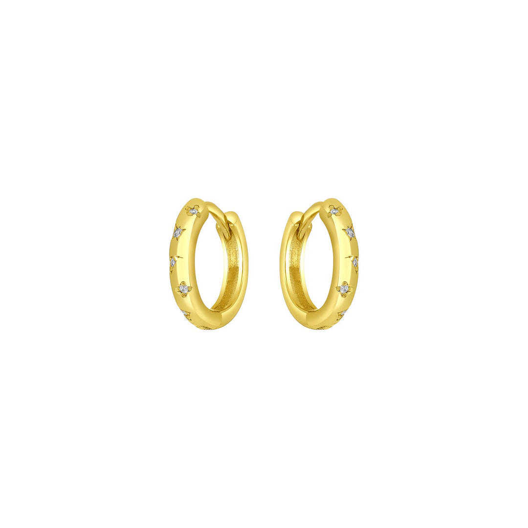 Gold huggie earrings with CZ stones and slim celestial-inspired design.