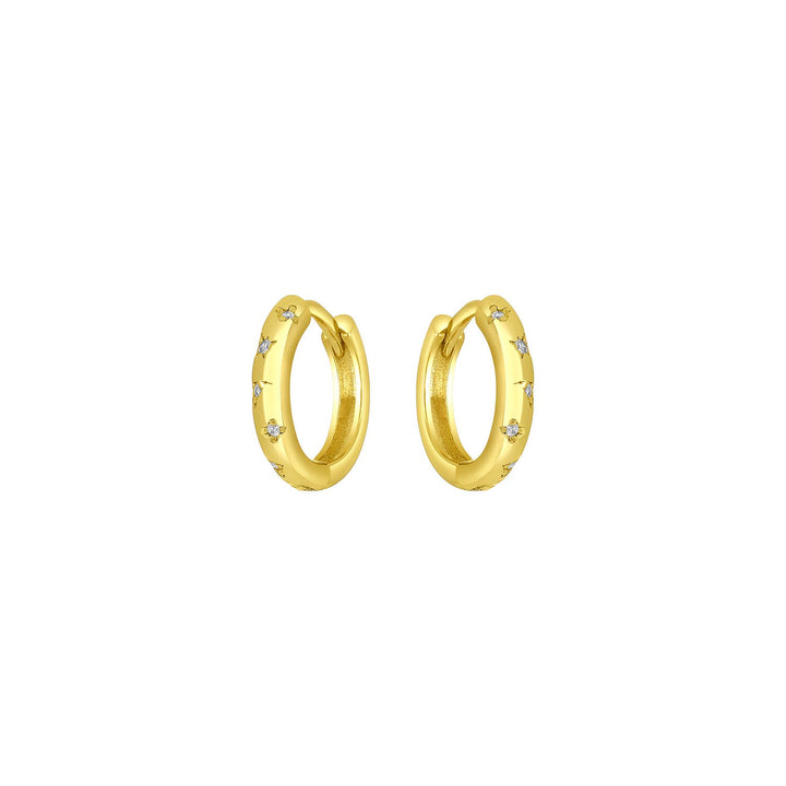 Gold huggie earrings with CZ stones and slim celestial-inspired design.