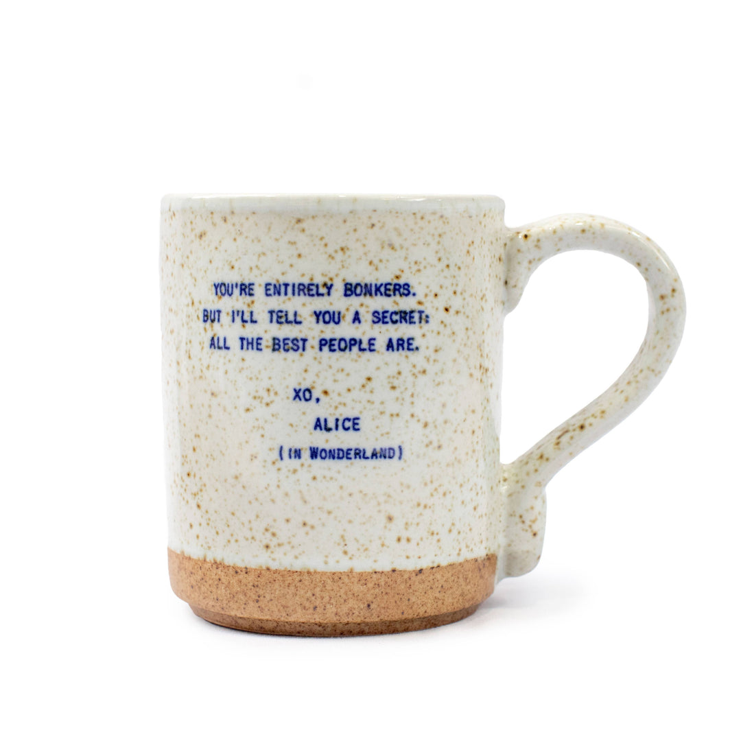 Handmade XO stoneware mug with Alice in Wonderland quote, speckled glaze, and neutral tones on a white background