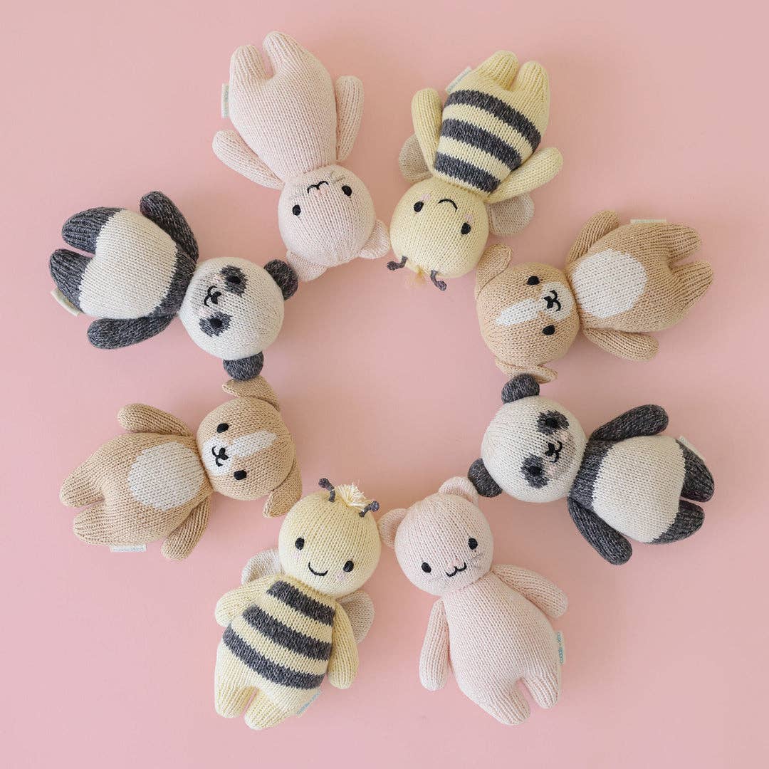 Set of knitted animal toys on a pink background