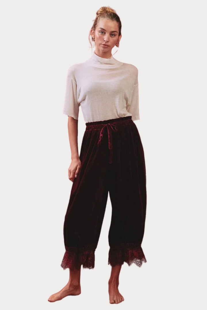 Deep merlot velvet bloomer pants with elastic drawstring waist, gathered legs and scalloped floral lace hems