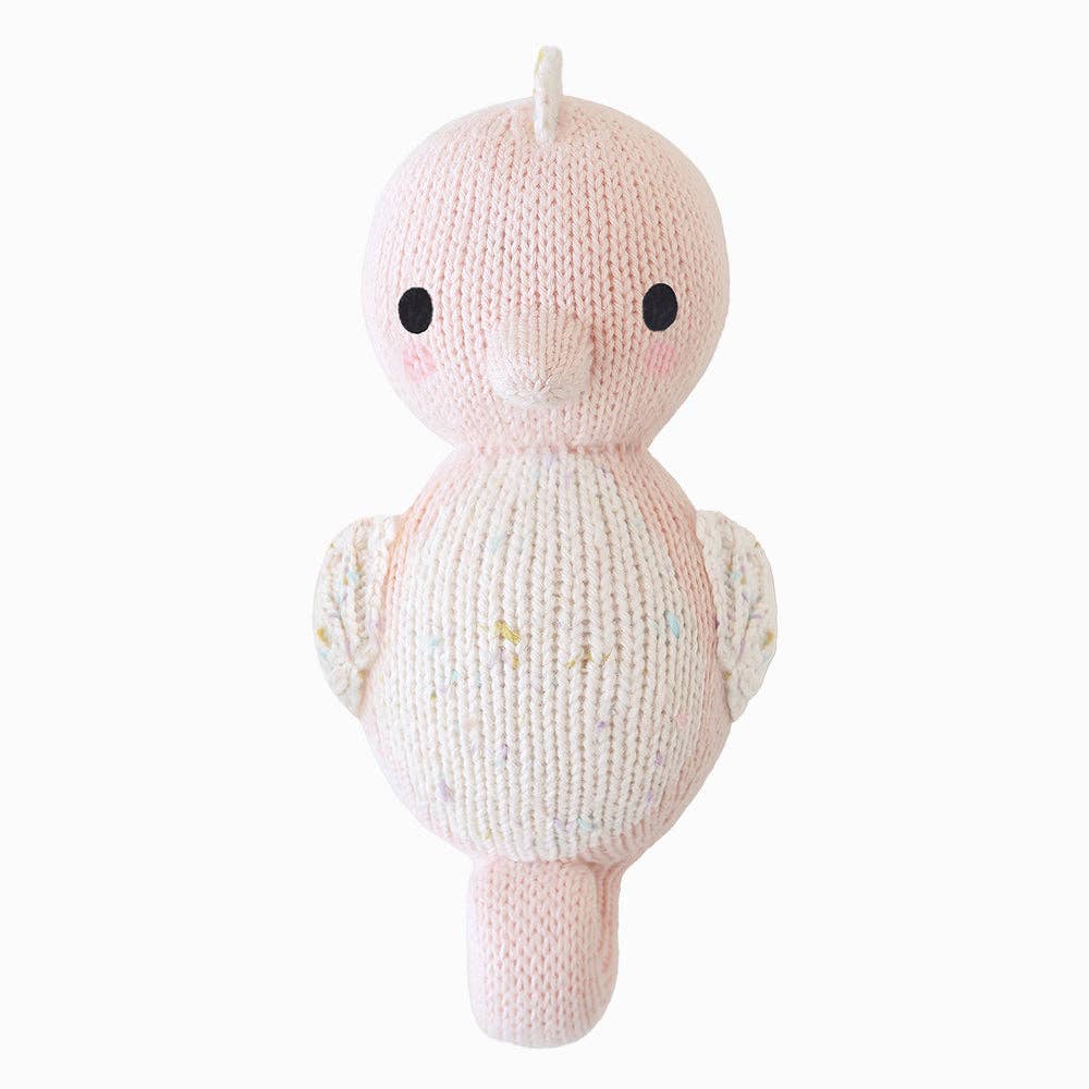 Knitted baby seahorse plush toy with a plain background