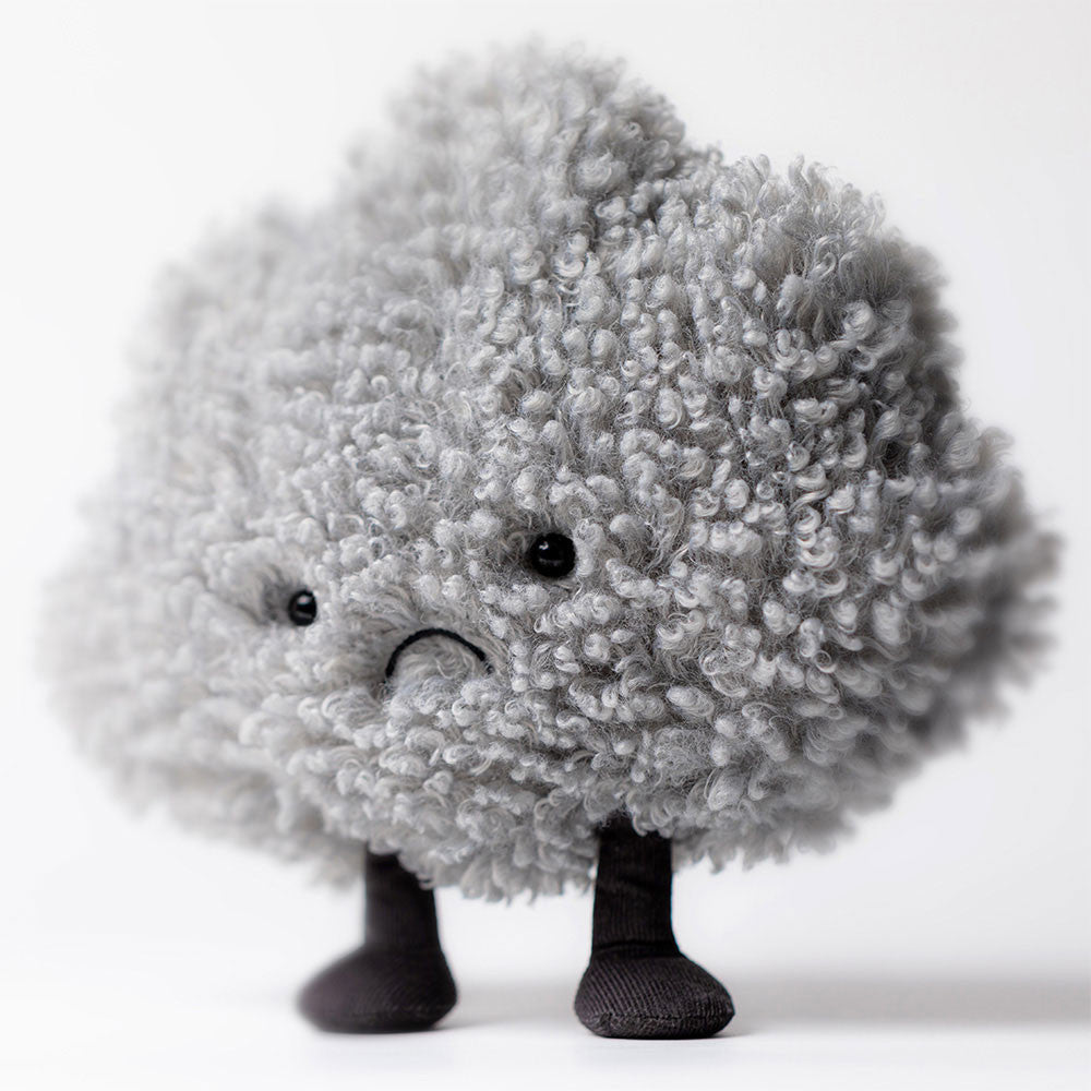 Jellycat Amuseable Storm Cloud plush, presented in a slightly elevated or standing pose, highlighting its full, round, curly grey form and expressive face.