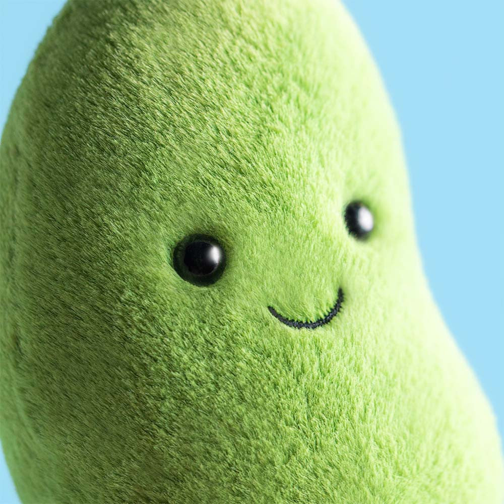 Closeup detail of face Amuseables Soyella Edamame Bean plush with soft green fur, smiling face, and brown corduroy feet