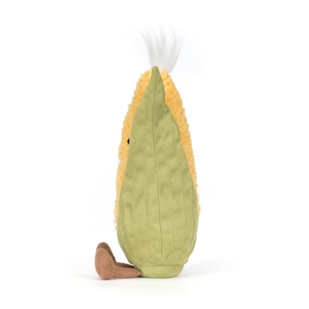 Amuseables Sweetcorn plush with soft yellow textured kernels, green husk detailing, and a smiling face on a white background. Facing left profile