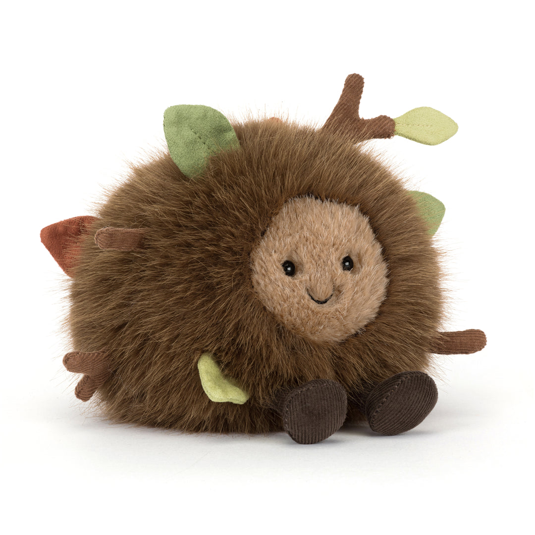 Amuseables Mulshi Woodland Floor Jellycat plush with fluffy brown fur, embroidered leaves and twigs, smiling face, and corduroy feet on a white background.