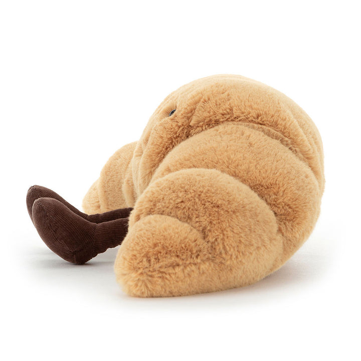 “Amuseables Croissant plush by Jellycat with smiling face and corduroy legs” side view