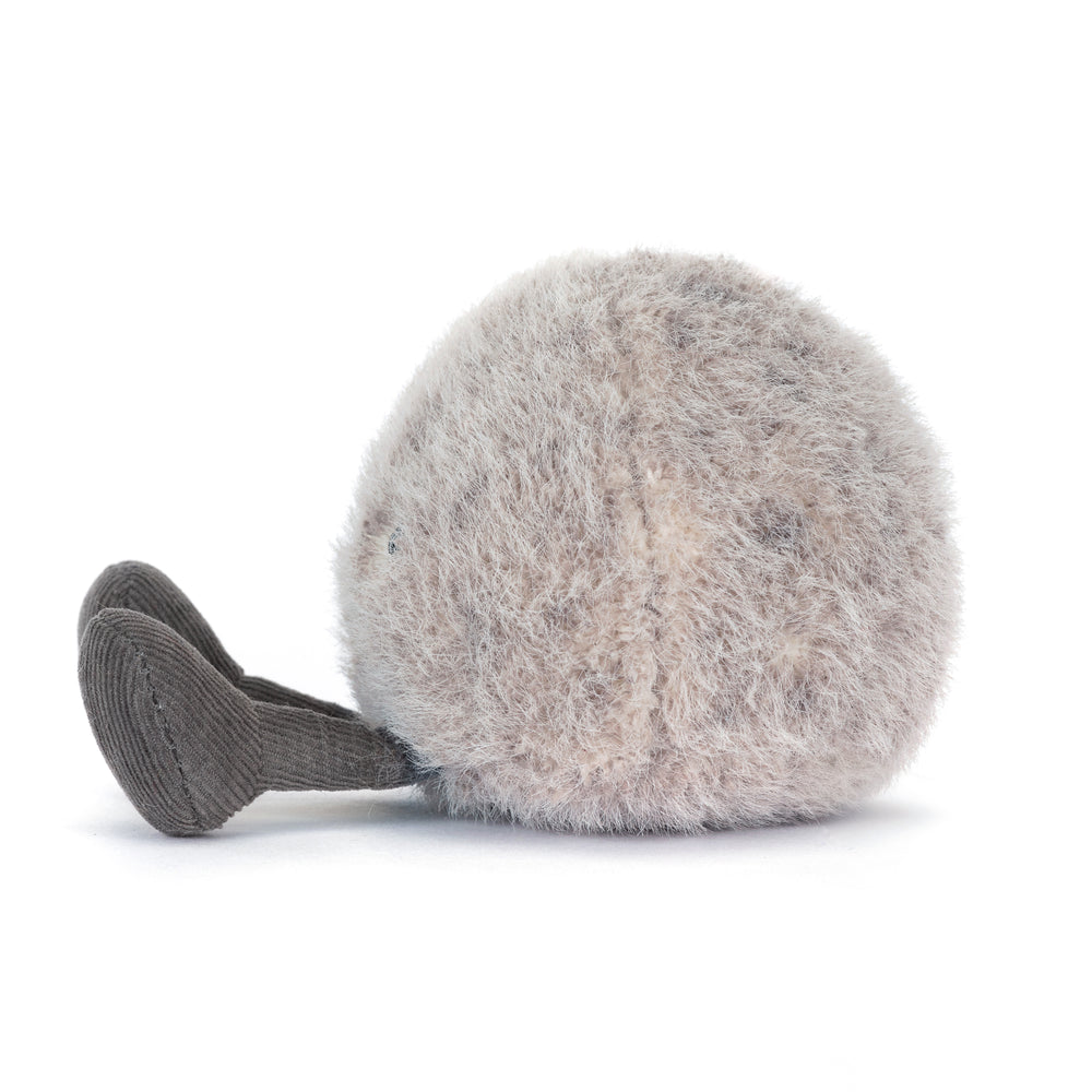 amuseables pebble plush in soft grey tones with smiling face and cord legs. Side View facing left